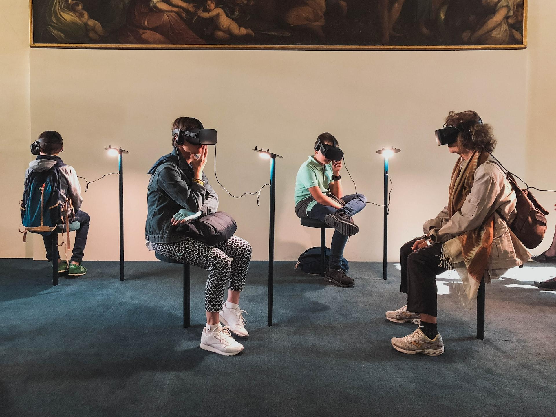 four person playing virtual reality goggles